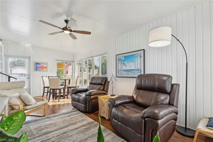 Living room featuring ceiling fan, hardwood / wood-style flooring, and a wealth of natural light