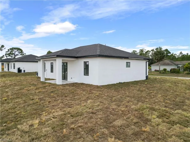 View of side of property featuring a yard