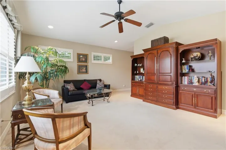 Living room with vaulted ceiling, light carpet, a ceiling fan, and recessed lighting