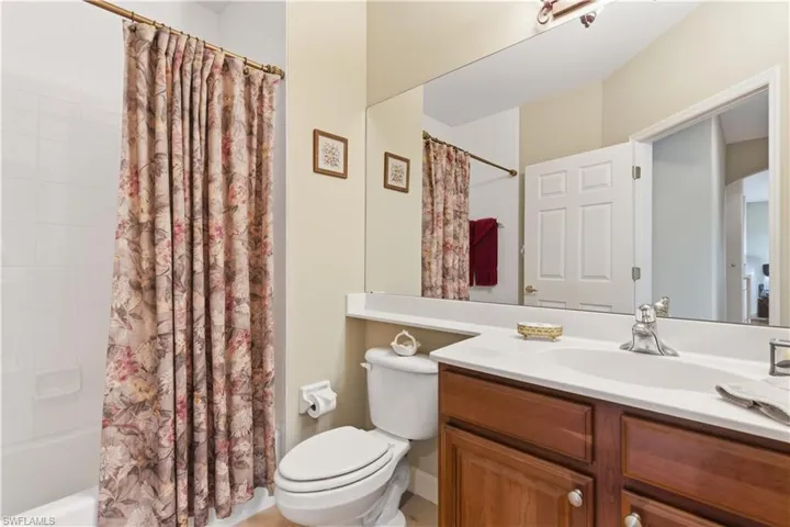 Full bath featuring shower / bathtub combination with curtain and vanity