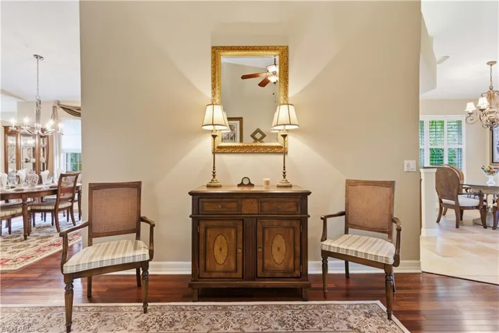 Living area with a chandelier and dark wood-style floors