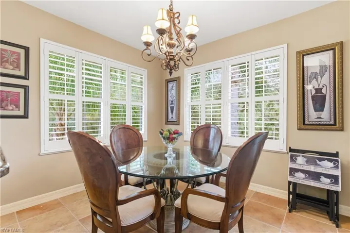 Dining area featuring light tile patterned floors and a chandelier