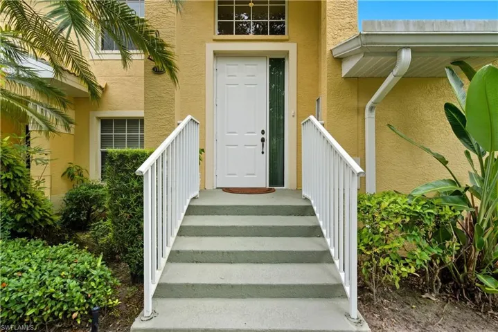 Entrance to property with stucco siding