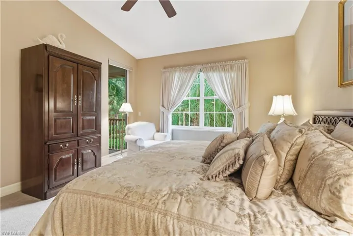 Bedroom featuring access to outside, light carpet, and a ceiling fan