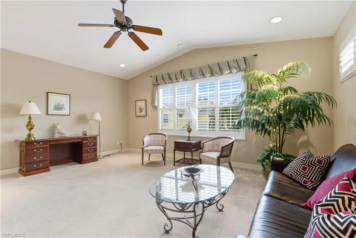 Living room with vaulted ceiling, carpet flooring, ceiling fan, a desk, and recessed lighting