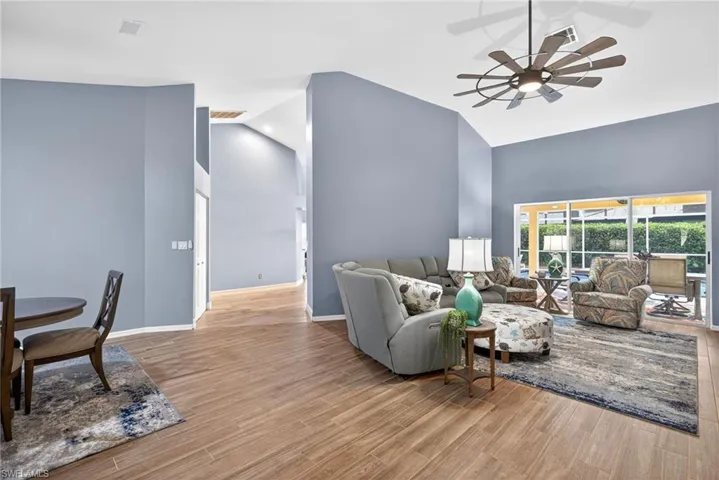 Living area featuring ceiling fan, light wood finished floors