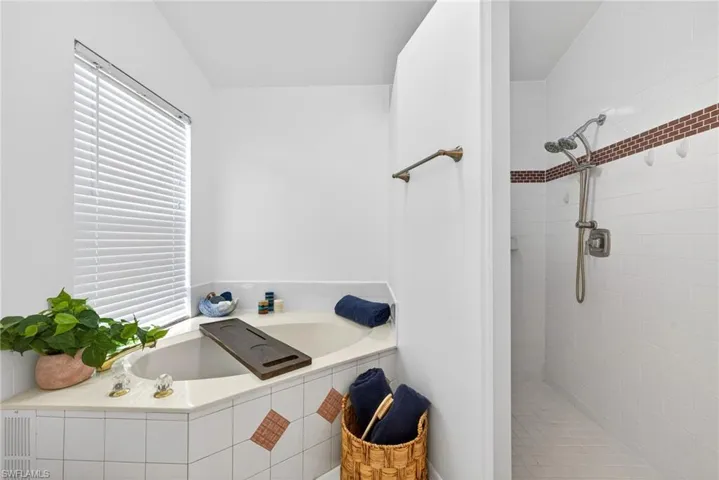 Bathroom featuring a garden tub and a walk in shower
