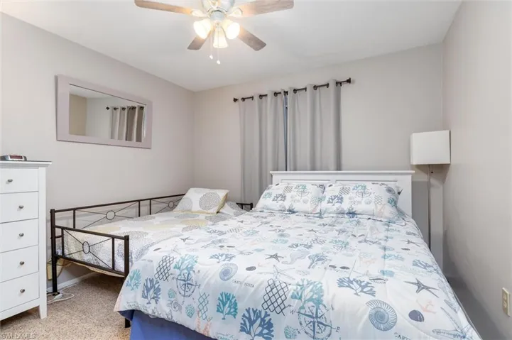 Bedroom with ceiling fan and carpet floors
