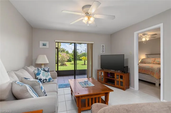 Living room featuring ceiling fan and light tile patterned floors