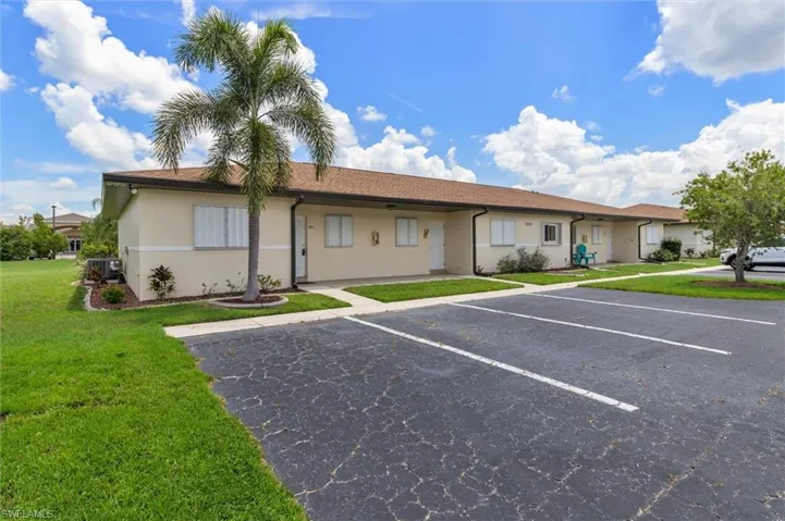 View of front of home featuring central AC and a front lawn