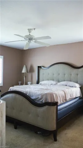 Carpeted bedroom with ceiling fan