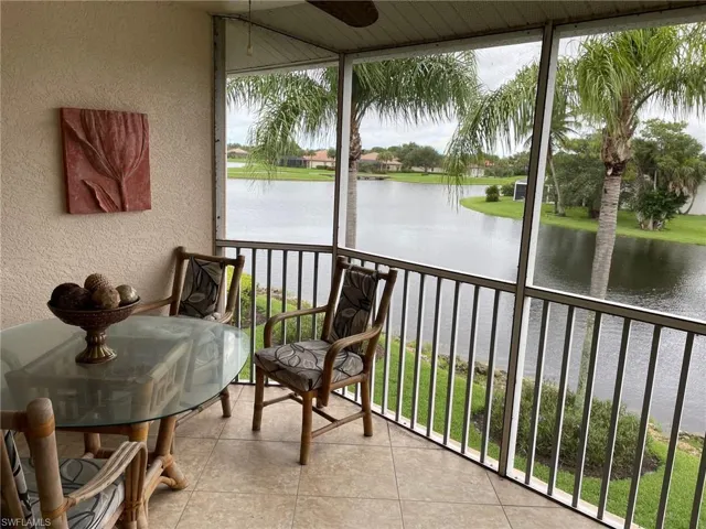 Sunroom featuring a water view