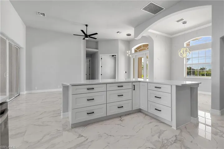 Bathroom featuring tile patterned flooring, ornamental molding, and ceiling fan