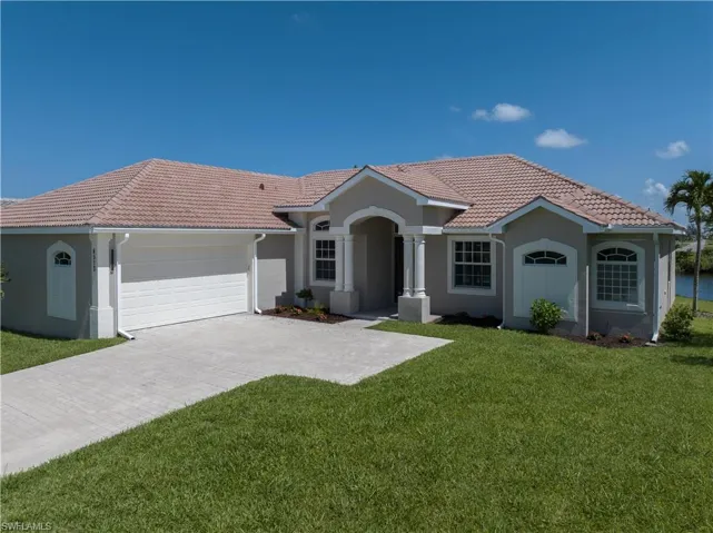 View of front facade with a garage and a front lawn