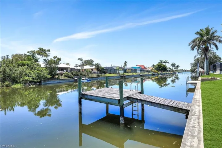 Dock with a water view and a residential view