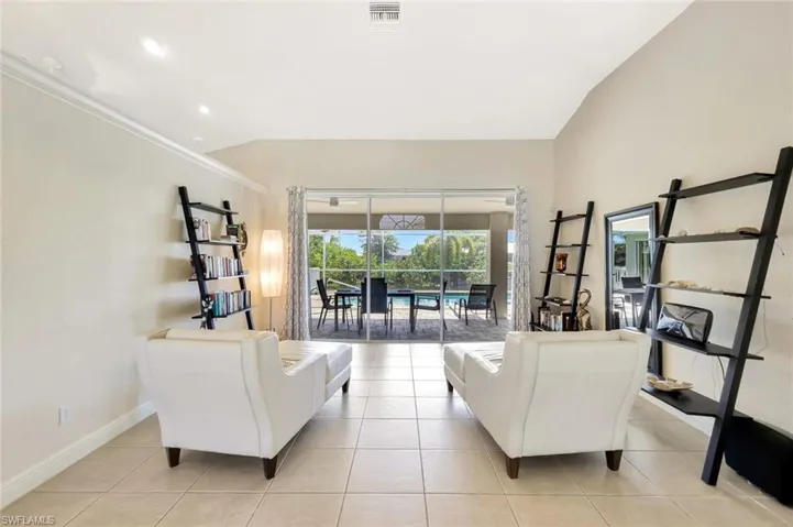 Living room with light tile patterned floors, recessed lighting, and baseboards