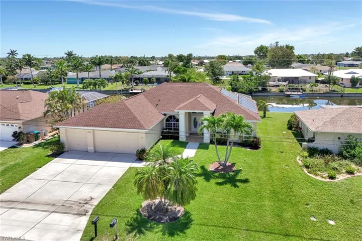 Mediterranean / spanish home with a garage, driveway, a residential view, and a front yard