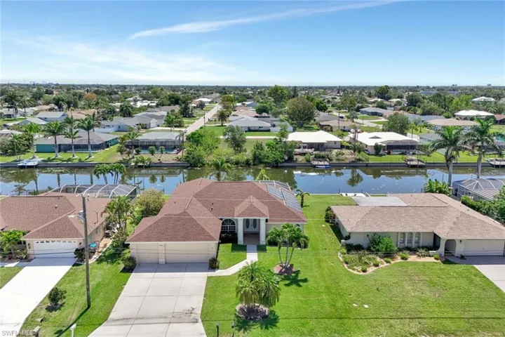 Aerial perspective of suburban area featuring a large body of water