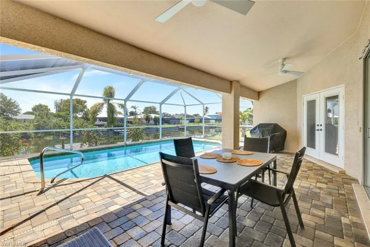 Swimming pool featuring a ceiling fan, french doors, a grill, and a patio