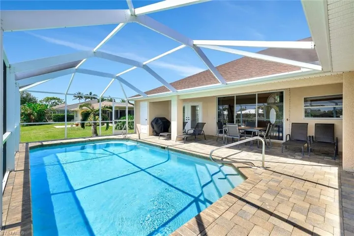 Swimming pool featuring a patio area and a lanai