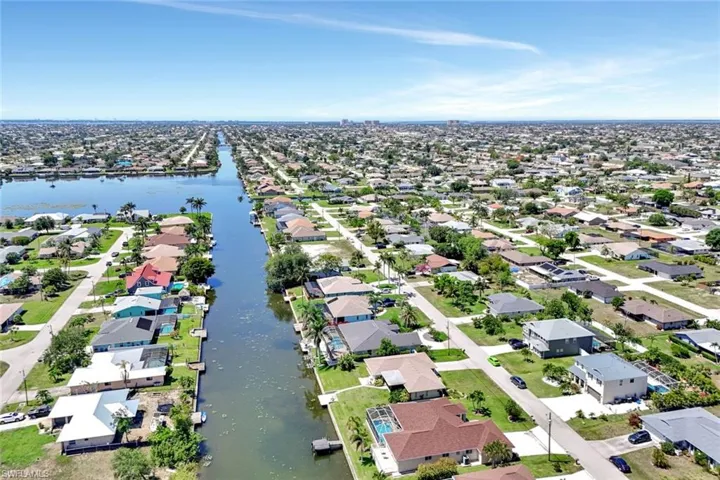 Aerial view of residential area featuring a large body of water