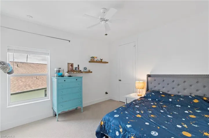 Bedroom featuring ceiling fan and carpet