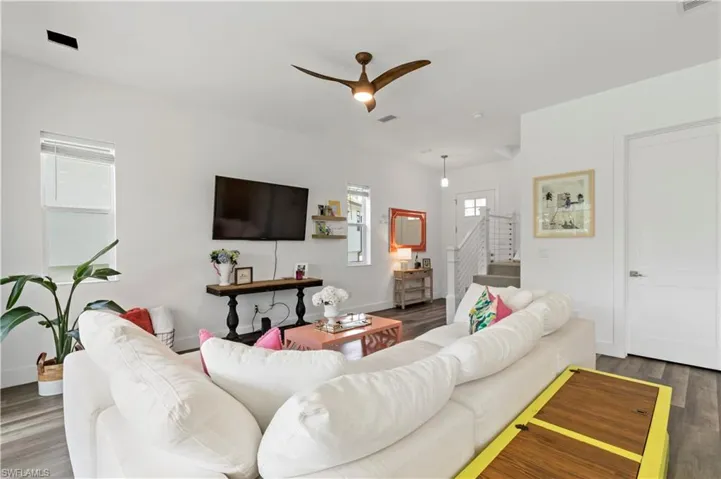 Living room with ceiling fan and wood-type flooring
