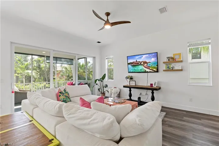 Living room featuring ceiling fan and dark hardwood / wood-style flooring