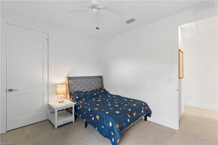 Carpeted bedroom with ceiling fan