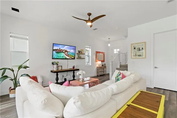 Living room with wood-type flooring and ceiling fan