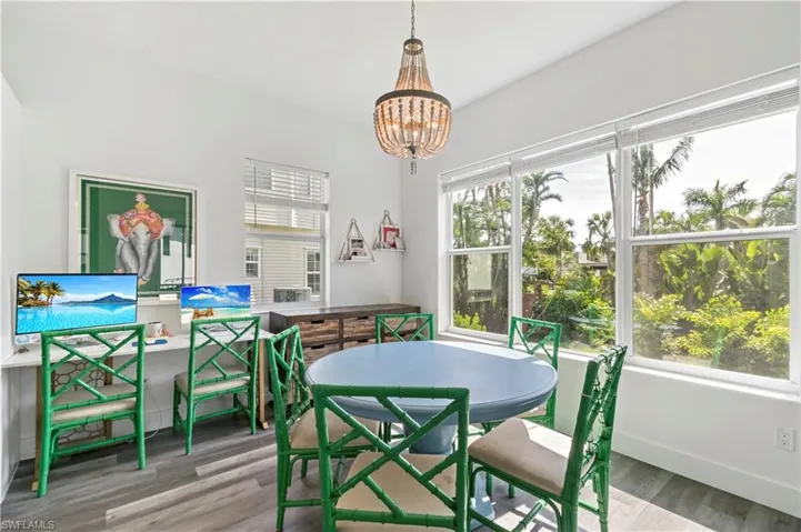 Dining space with hardwood / wood-style floors and a notable chandelier
