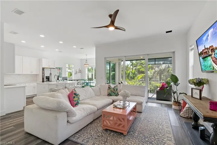 Living room featuring ceiling fan, dark hardwood / wood-style flooring, and sink