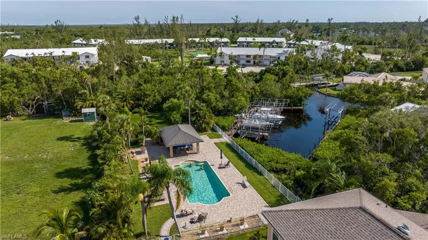 Birds eye view of property with a water view