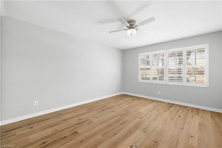 Spare room featuring light wood-type flooring, a ceiling fan