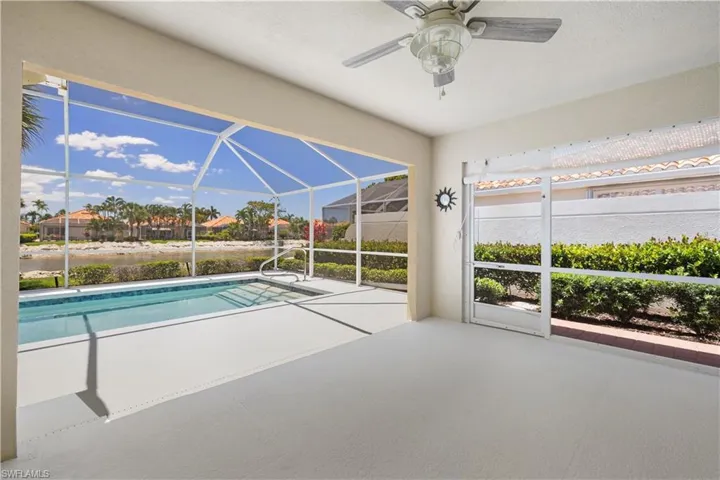 Outdoor pool featuring a patio area, a ceiling fan, and a lanai