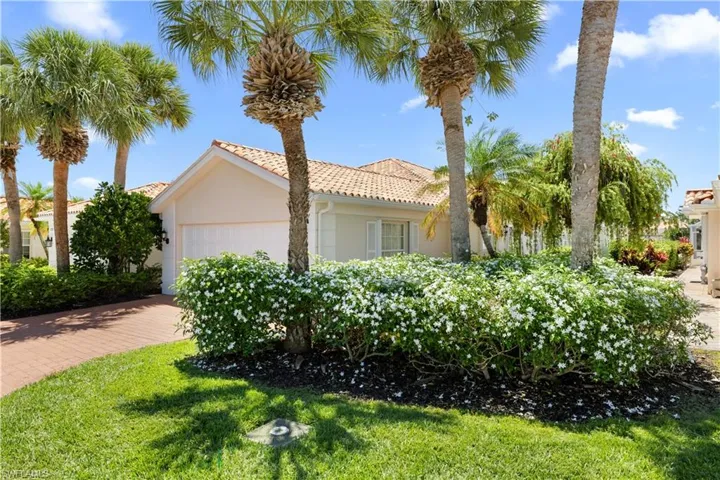 View of property exterior with stucco siding, a garage, and driveway