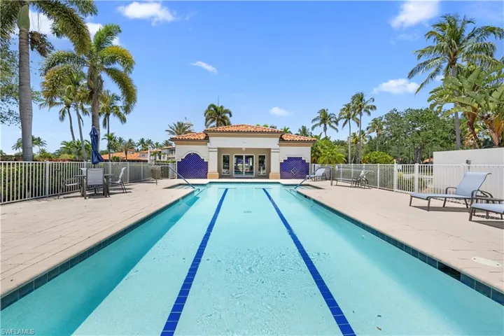 Community pool featuring fence and a patio