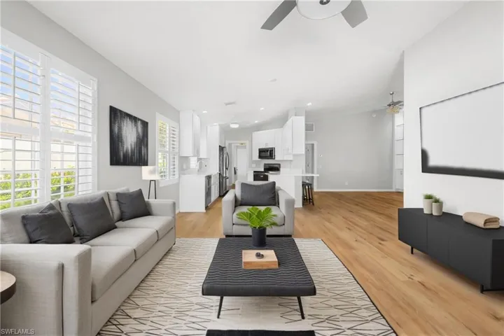 Virtual staging for living room with ceiling fan, light wood finished floors, baseboards, and recessed lighting