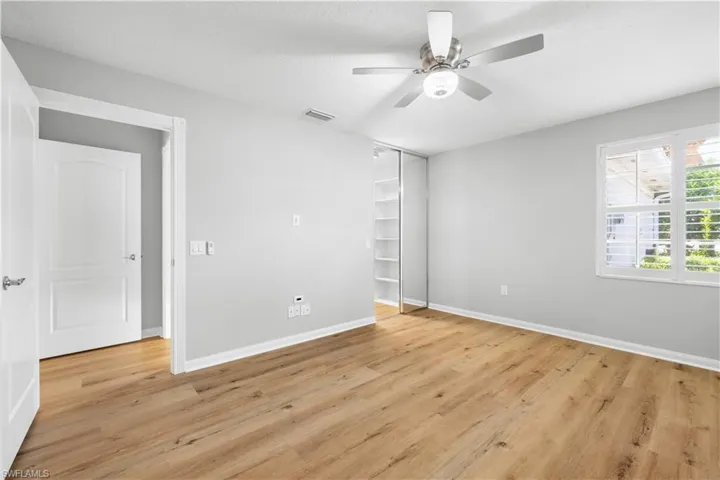 Unfurnished bedroom with light wood finished floors, baseboards, and ceiling fan