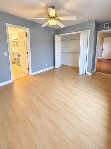 Wood-finish flooring, ceiling fan with integrated lighting, bi-fold closet doors with wire shelving