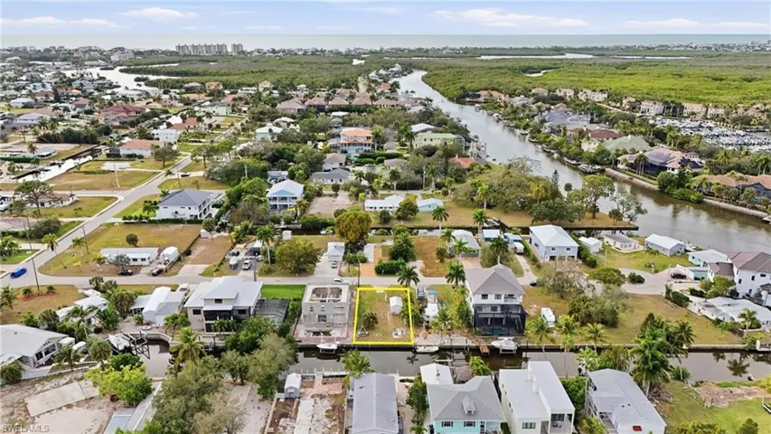 Aerial overview of property's location with nearby suburban area and a large body of water