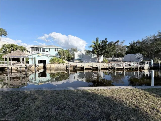 Dock area featuring a yard and a water view
