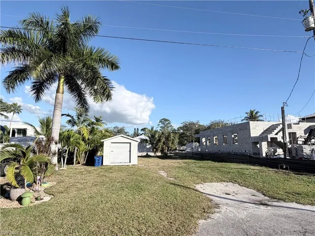 View of grassy yard with a shed
