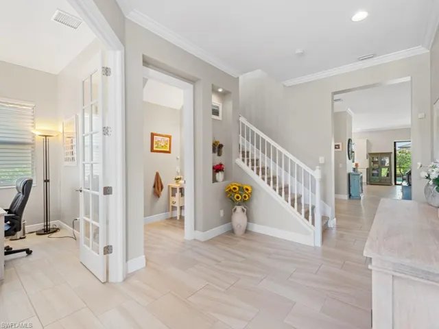 Stairs featuring french doors, visible vents, crown molding, and baseboards
