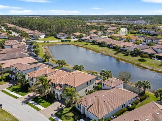 Aerial view featuring a water view and a residential view