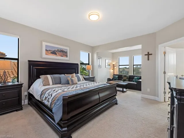 Bedroom featuring light carpet and baseboards