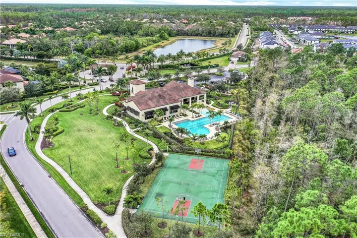 Birds eye view of property with a water view