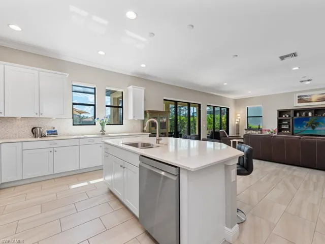 Kitchen featuring a sink, plenty of natural light, visible vents, and dishwasher