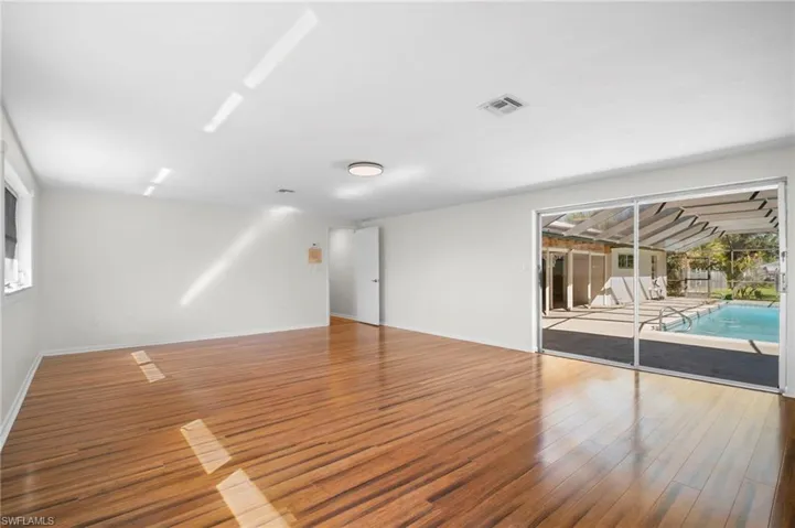 Spare room featuring light wood finished floors and baseboards