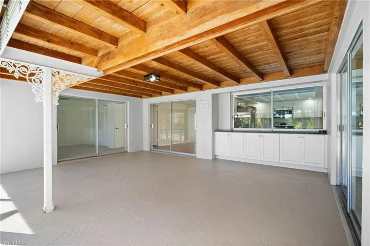 Unfurnished sunroom with beamed ceiling
